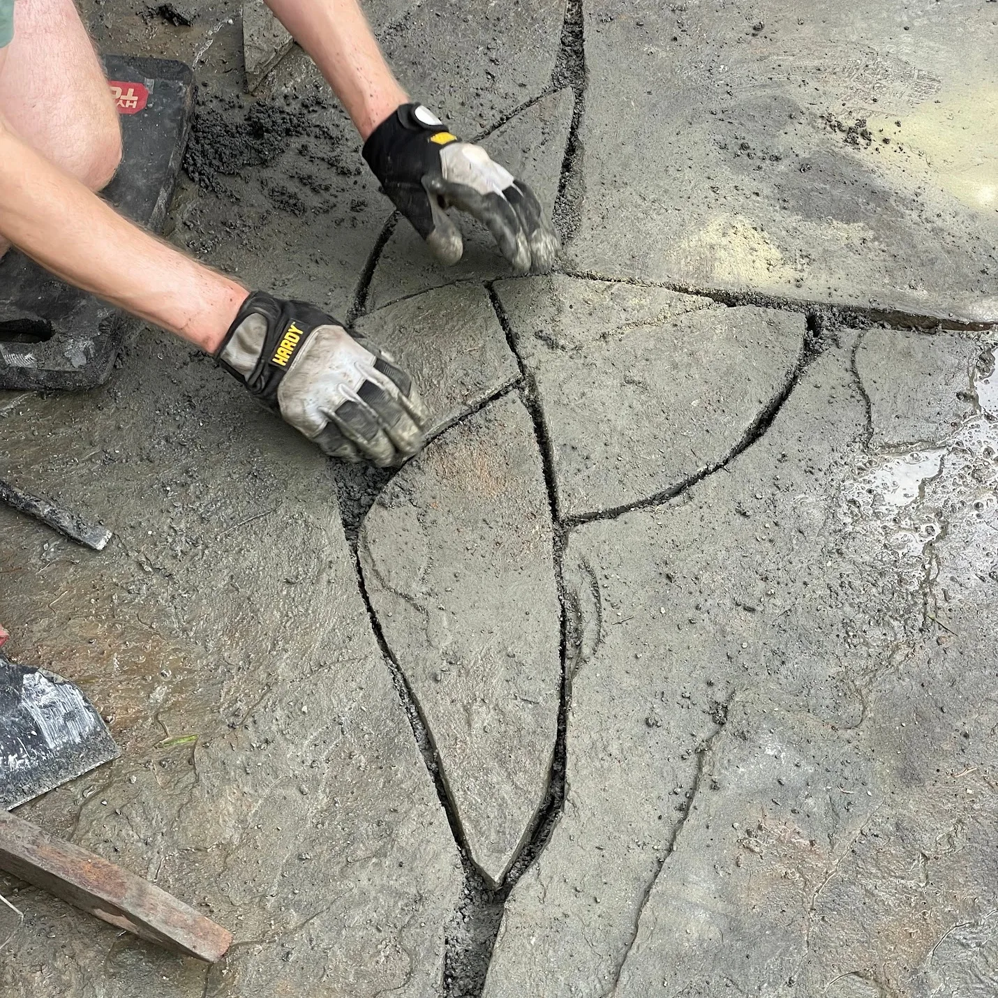 Puzzling together pieces of bluestone to form a patio.
